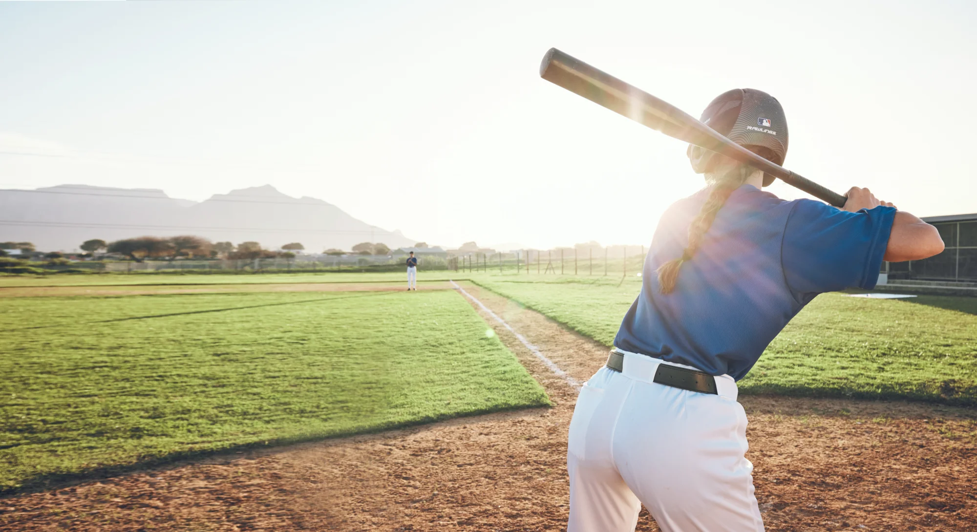 Girl playing softball in the summer